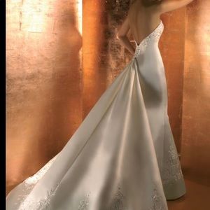 New with tags Demetrios strapless wedding gown.